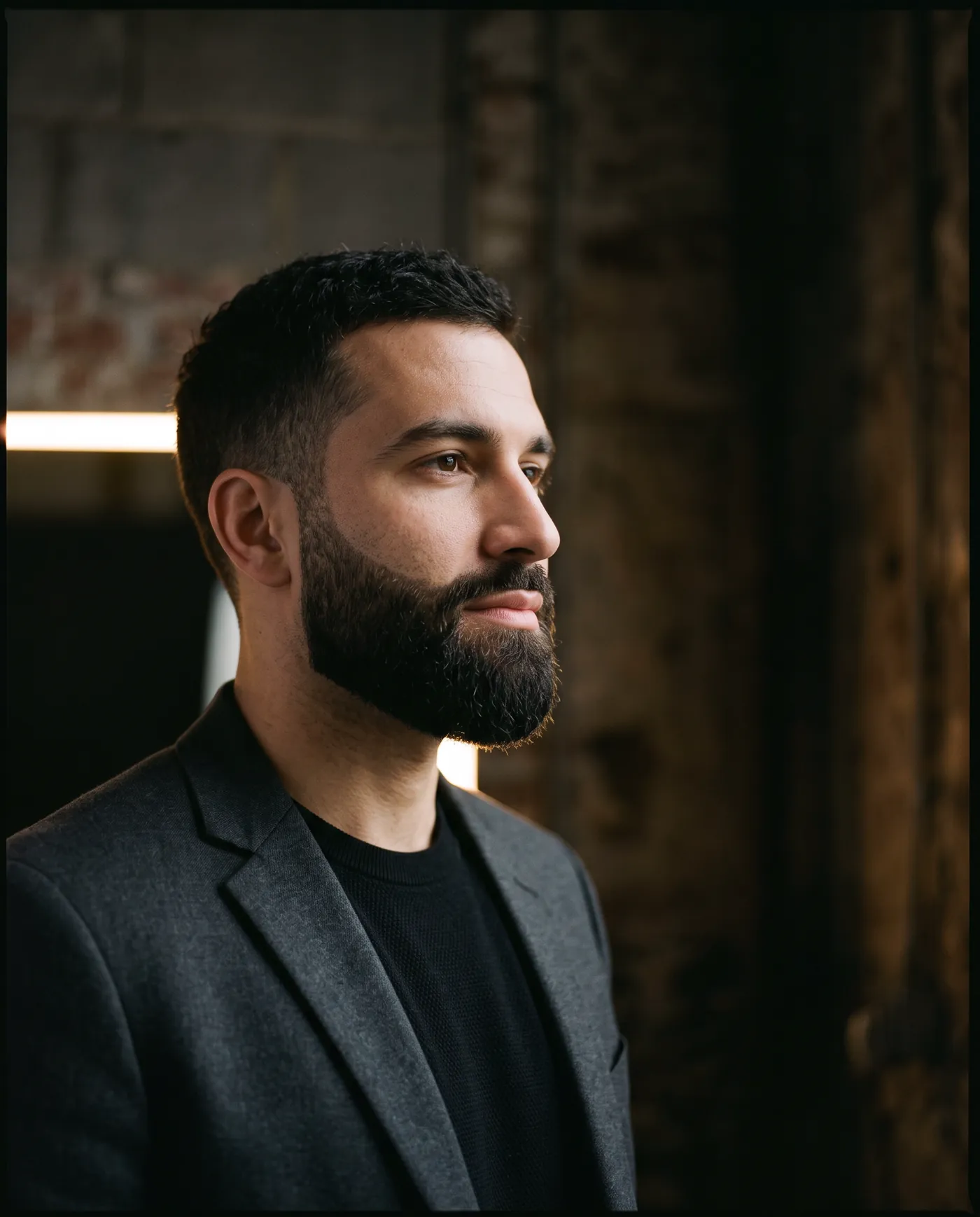 Three-quarter portrait of a short sculpted full beard with a precise cheek line
