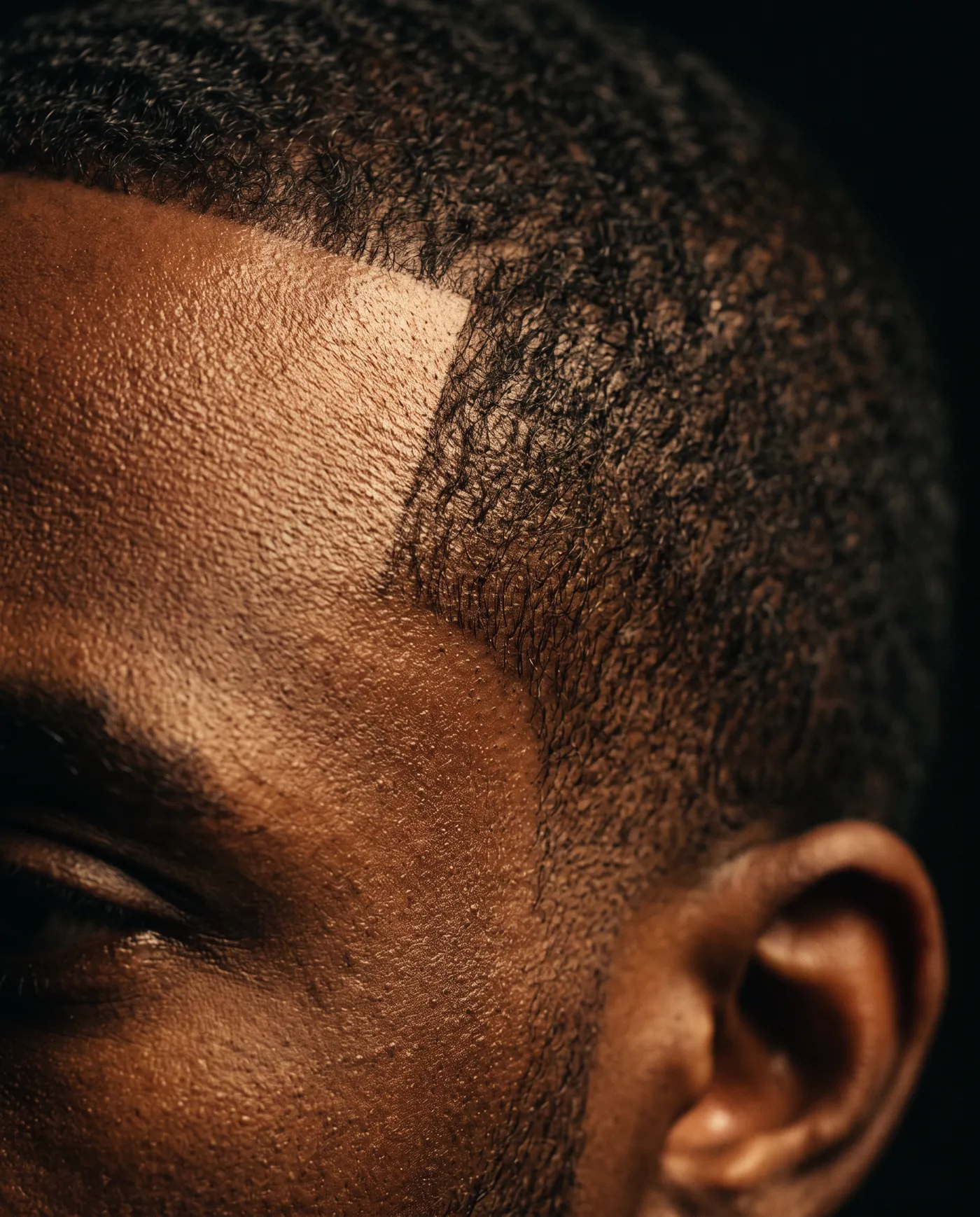 Close detail of a razor-sharp hairline and temple corner